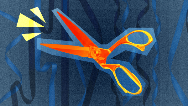 Red scissors on blue background, signifying the idea of Federal Reserve Bank interest rate cuts.