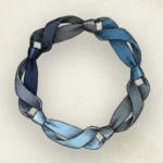 Five neckties tied together representing integrated professional relationships.